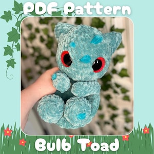 May include: A crocheted blue plush toy shaped like a toad with red eyes. The toy is being held by a hand. The text "PDF Pattern" and "Bulb Toad" are visible in the image.
