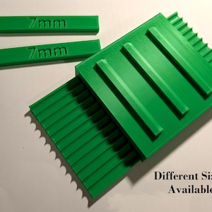 May include: Green 3D-printed objects. Two rectangular pieces display "7mm" text. Larger, textured green pieces are also visible, with the text "Different Sizes Available".