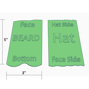 May include: Two green fabric patches, each measuring 3 inches by 5 inches. The left patch has the words "Face", "BEARD", and "Bottom" printed on it. The right patch has the words "Hat Side", "Hat", and "Face Side" printed on it.