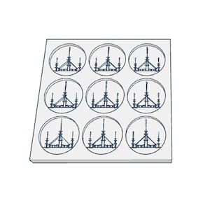 May include: A white tray with nine circular compartments, each containing a black and white line drawing of a chandelier with five lights.