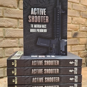 May include: A stack of six paperback books with the title "Active Shooter: The American Mass Murder Phenomenon" by M.P. Priestley. The cover of the top book features a black and white image of a rifle.