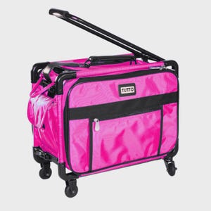 May include: A bright pink rolling luggage bag with a black frame and handle. The bag features a rectangular shape, multiple zippered compartments, and four small wheels at the base. A black rectangular patch with the white text TUTTO is centered.