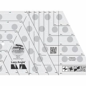 May include: A clear acrylic quilting ruler labeled Lazy Angle by Creative Grids. The tool features black printed measurement markings, grid lines, a QR code, and circular non-slip grips. Text includes Creative Grids, Lazy Angle, and Designed by Lazy Girl Designs Joan Hawley, with various geometric pattern illustrations.