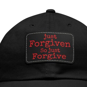 May include: Black baseball cap with a red embroidered patch that says "Just Forgiven So Just Forgive"