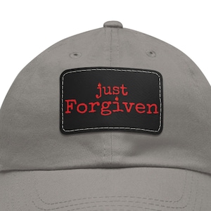 May include: A gray baseball cap with a black patch that says "just forgiven" in red lettering.