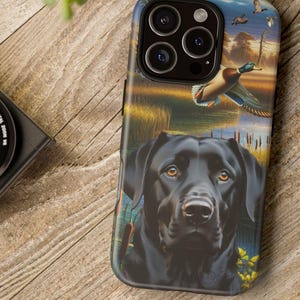 May include: A black Labrador Retriever phone case with a wildlife scene featuring ducks in flight over a marsh. The case has a glossy finish and is designed for a smartphone.