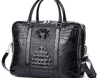 May include: A glossy black briefcase with a crocodile skin texture. The bag has two top handles, a silver zipper, and a detachable shoulder strap. The front features a decorative embossed design.