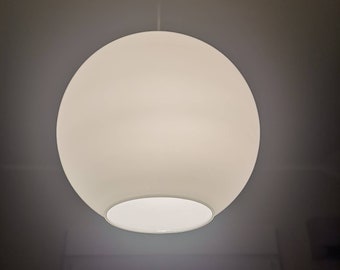 May include: A white, round, frosted glass pendant light fixture hangs from the ceiling.