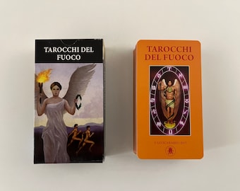 May include: Two tarot card decks, both with orange backgrounds and the text "Tarocchi del Fuoco" in red. The left card features a woman with wings holding a torch, while the right card shows a man with wings holding a staff.