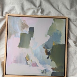 May include: Abstract artwork in a wooden frame. The painting uses a palette of soft colours, including pink, green, blue, and white, with visible brushstrokes. The artwork has a modern, minimalist style.