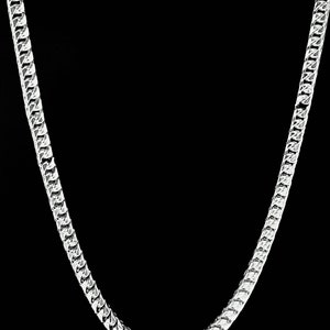 May include: A silver chain necklace with a curb link style. The chain is made of metal and has a shiny finish.