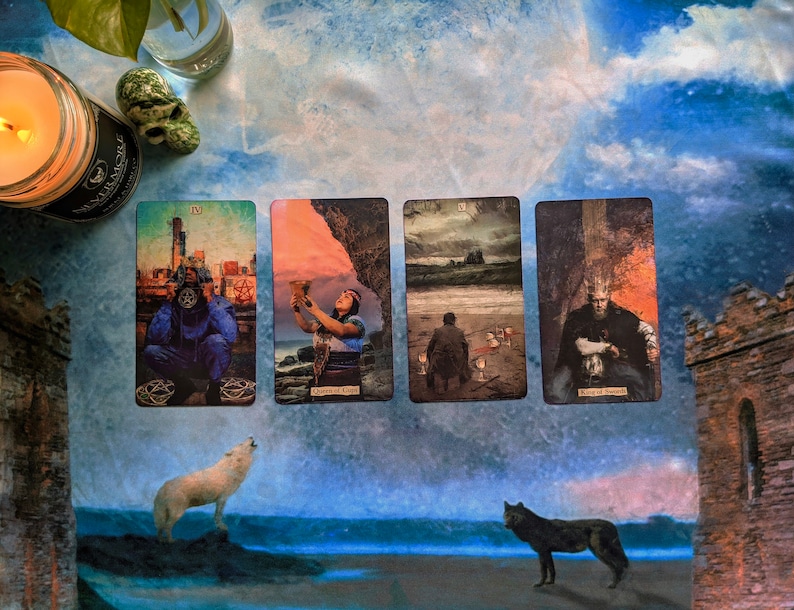 May include: Four tarot cards laid out on a blue and white patterned surface. The cards are "The Tower", "Queen of Cups", "Five of Swords", and "King of Swords". The cards are surrounded by a white candle, a skull, and two wolves.