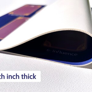 May include: A white playing mat with a blue border and gold accents. The mat is 1/8th inch thick and features the text "6- Influence".