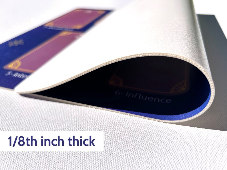 May include: A white playing mat with a blue border and gold accents. The mat is 1/8th inch thick and features the text "6- Influence".