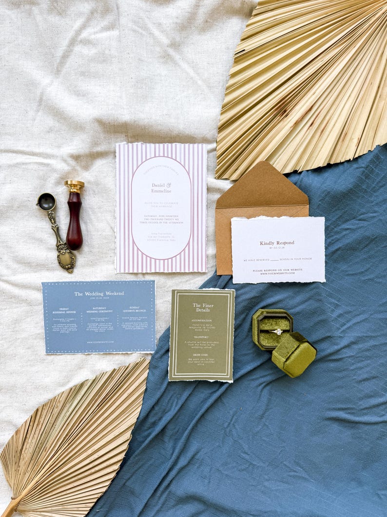 May include: Wedding invitation suite with a pink and white striped card, a blue card with the wedding weekend schedule, a green card with the finer details, a brown envelope with a white RSVP card, and a green ring box with a diamond ring.