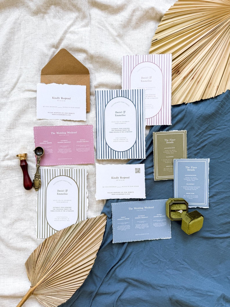 May include: A set of wedding invitations with a striped design in blue, pink, and green. The invitations include details about the wedding weekend, the finer details, and a RSVP card. The invitations are on a blue and white fabric background.