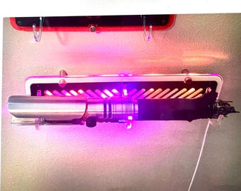Lightsaber Staff wall mounted stand with Animation lighting. Made from Laser Cut Cast Acrylic. Holds most lightsabers.