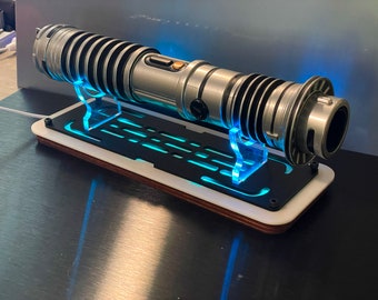 Lightsaber Stand with Animation lighting, flat for desk or shelf. Made from Laser Cut Cast Acrylic. Holds most jedi lightsabers.
