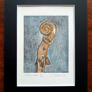 May include: A close-up of the scroll of a violin, painted in brown and gold tones against a blue background. The image is signed "Schucdee '22" and "S.Harse '22".