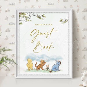 K&ouml;nnte beinhalten: Ein wei&szlig; gerahmtes Schild mit Winnie Puuh-Motiv. Das Schild tr&auml;gt die Aufschrift "Bitte unterschreiben Sie unser G&auml;stebuch" in goldenen Lettern. Die Figuren Winnie Puuh, Tigger, Ferkel und Esel sind unten auf dem Schild abgebildet.