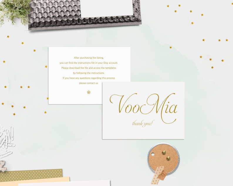 K&ouml;nnte beinhalten: Eine wei&szlig;e Karte mit goldener Schrift, auf der "Voo Mia" und "Vielen Dank!" steht. Die Karte liegt auf einem wei&szlig;en Hintergrund mit goldenen Sternen.