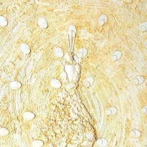 May include: A white textured canvas painting of a stylized peacock with a yellow background. The peacock's tail feathers are made of raised circles and the body is textured.