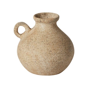 May include: A small, beige ceramic vase with a textured surface and a single handle. The vase has a rounded body and a slightly flared opening.