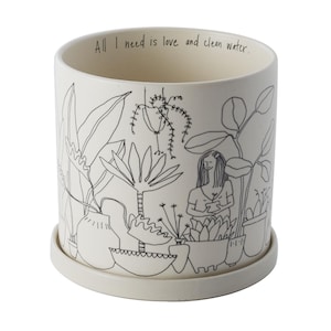 May include: White ceramic planter with a black line drawing of a woman tending to plants. The text "All I need is love and clean water." is printed on the planter.