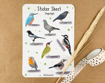May include: A sticker sheet with illustrations of different birds, including a robin, a woodpecker, a magpie, a bluebird, a dove, a starling, a green woodpecker, and a jay. The sheet is titled "Sticker Sheet Singvogel" and has the text "@Svala print" at the bottom.