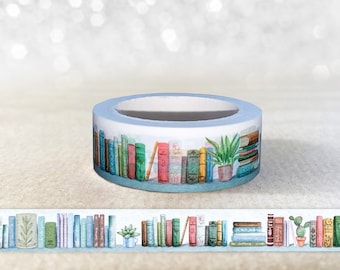May include: A roll of blue washi tape with a pattern of colorful books and plants. The tape is on a white background.