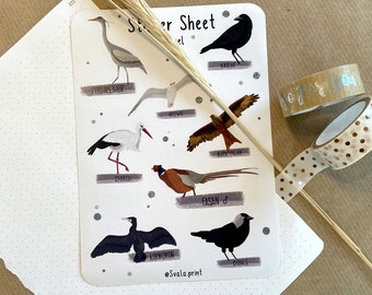 May include: A sticker sheet with illustrations of different birds, including a heron, stork, crow, and pheasant. The sheet is white with gray and brown accents. The text "Sticker Sheet" is at the top of the sheet.