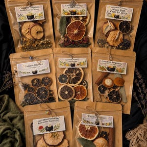 May include: Eight brown paper pouches containing dried botanical potpourri blends. Each pouch features a label reading Cauldron Potpourri with specific scent names like Moonlit Peace, Winter Orchard, Moon Bath, Evil Eye Reversal, and Rosewater Daydreams.
