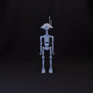 May include: A grey, articulated robot toy with a dome-shaped head and two antennas. The robot has a single eye and is standing on a black surface.