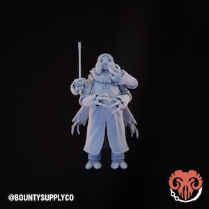 May include: A light blue figurine of a humanoid creature with multiple arms, a bulbous head, and a long coat. The figure is holding a thin, white rod. The text "@BOUNTYSUPPLYCO" is at the bottom left.