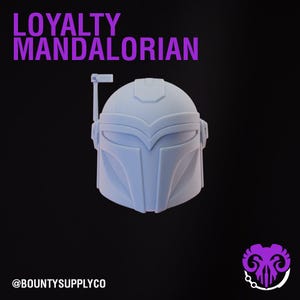 May include: A light blue Mandalorian helmet with the text "LOYALTY MANDALORIAN" in purple. The helmet is set against a black background. The @BOUNTYSUPPLYCO logo is at the bottom.