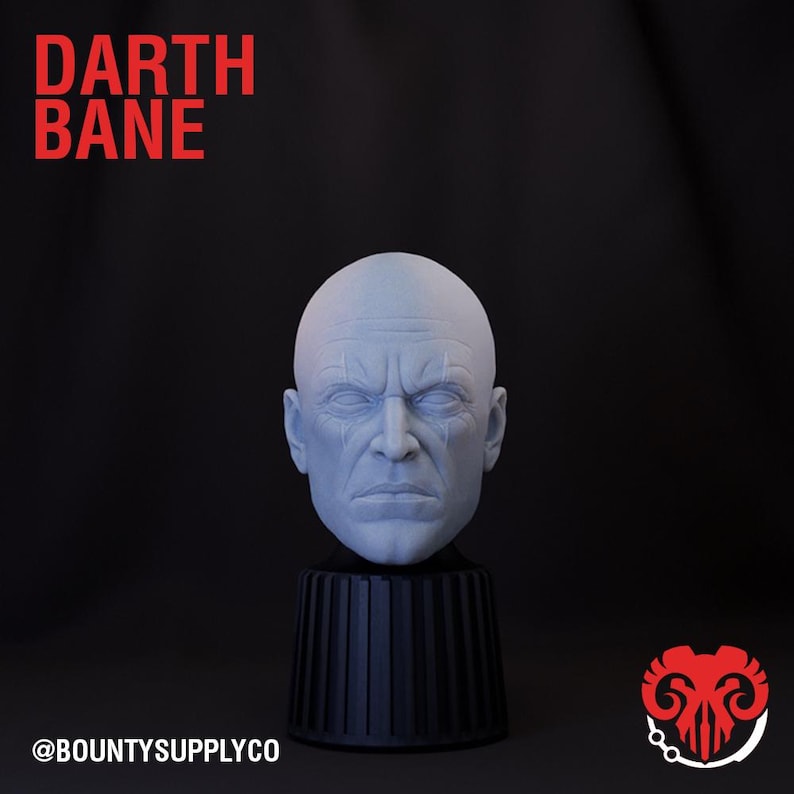 May include: A white 3D printed bust of Darth Bane, a fictional character from the Star Wars universe. The bust is on a black pedestal with a ribbed design. The image includes the text "DARTH BANE" and "@BOUNTYSUPPLYCO".