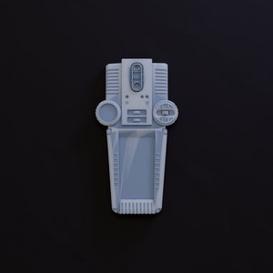 May include: A white handheld device with a screen, buttons, and a dial. The device has a textured surface and a gray color.