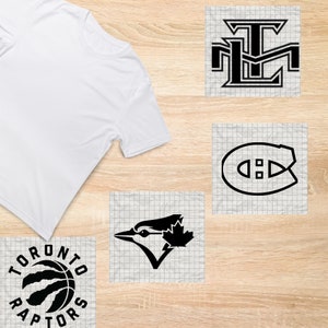 May include: A white t-shirt with four different logos printed on it. The logos are for the Toronto Raptors, the Toronto Maple Leafs, the Montreal Canadiens, and the Toronto Blue Jays.