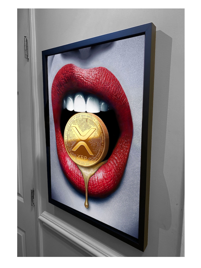 May include: A framed canvas print of a pair of red lips with a gold XRP cryptocurrency coin inside. The coin is dripping gold liquid.