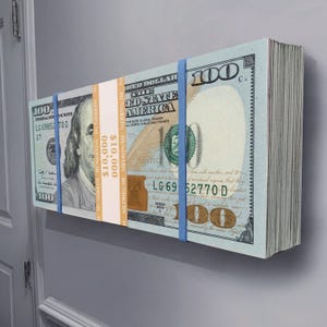 May include: A stack of $100 bills secured with blue rubber bands. The bills feature a portrait of Benjamin Franklin and the text "The United States of America". The stack is labeled "$10,000".
