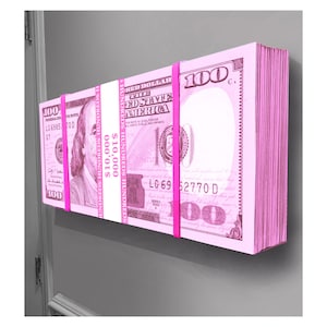 May include: A stack of pink hundred pound notes banded together with pink rubber bands. The notes are arranged vertically and the text "£10,000" is printed on the side of the stack.