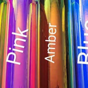 May include: Six iridescent bottles with labels reading "White", "Yellow", "Pink", "Amber", "Blue", and "Green".