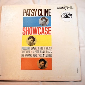May include: Vintage Patsy Cline "Showcase" vinyl record album cover. The album cover features the artist's name in large black letters, with the word "Showcase" in red. The cover includes a photo of Patsy Cline and the song titles "Crazy" and "I Fall to Pieces".
