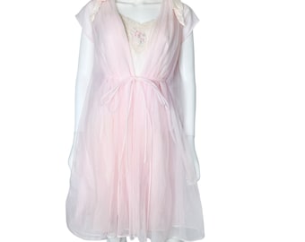 May include: A pink sheer nightgown with a lace trim and a satin bow at the shoulders. The gown has a tie at the waist and a flowing skirt.