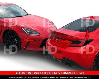 May include: Red car with dark tint precut decals. The image shows the front and rear of the car with arrows pointing to the decal placement. The text at the bottom reads "DARK TINT PRECUT DECALS COMPLETE SET".