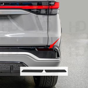 May include: Rear view of a silver SUV with black accents. The image highlights the taillight and bumper details. Two black trim pieces are shown at the bottom. The word "DESIGN" is visible in the background.