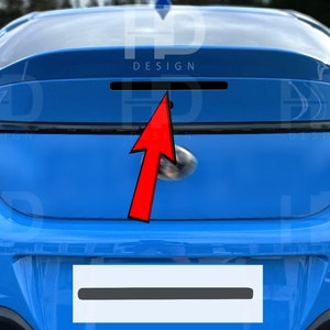 May include: Rear view of a blue car with a black spoiler and a black license plate. The car has a black trim around the rear window and a black rear bumper. The word "DESIGN" is printed on the spoiler.