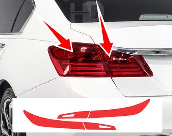 May include: Red tail light covers and matching red accent pieces for a white car. The tail lights are rectangular with horizontal lines. The accent pieces are curved and designed to fit the car's body.