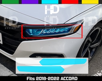 May include: A set of two blue headlight overlays for a 2018-2022 Honda Accord. The overlays are shown on a white car with black accents. The overlays are designed to give the headlights a more modern look. "Fits 2018-2022 Accord" is written in black text at the bottom of the image.