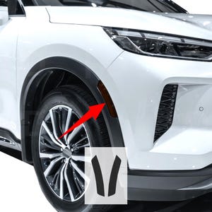 May include: Close-up of a white car's front side, showcasing a wheel and a dark-colored fender. An amber side marker light is visible. The image includes a red arrow pointing to the side marker light and a graphic of two black V-shaped pieces.